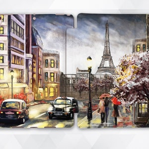 May include: A split-flap phone case with a painting of a Parisian street scene. The left side shows a city street with a taxi and a street lamp. The right side shows the Eiffel Tower and a couple walking under umbrellas.