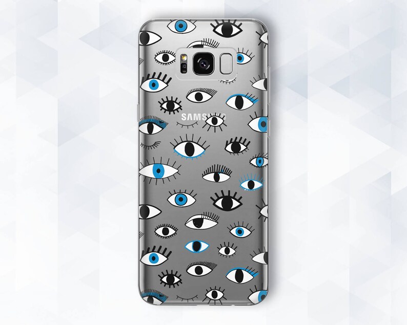 May include: A clear phone case with a pattern of blue and black eyes. The case is designed for a Samsung phone and has a cutout for the camera lens.