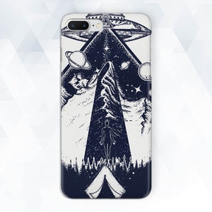 May include: A phone case with a black and white illustration of a mountain, a UFO, and a person standing in front of a tent. The background is a starry sky with planets.