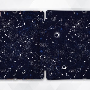 May include: A navy blue iPad case with a constellation pattern. The case features white stars, constellations, and celestial bodies on a dark blue background.