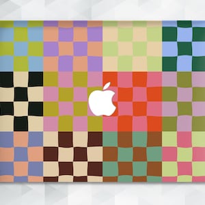 May include: A colorful checkered laptop skin with a white Apple logo in the center. The skin is made up of 12 squares, each with a different checkered pattern in shades of blue, green, pink, yellow, and brown.