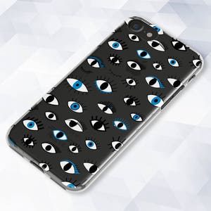 May include: A clear phone case with a black background and a pattern of blue and white eyes.