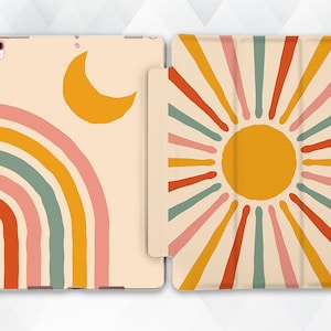 May include: A cream-colored iPad case with a rainbow, sun, and crescent moon design. The front of the case features a rainbow with pink, orange, yellow, green, and red stripes. The back of the case features a sun with yellow, orange, and red rays.