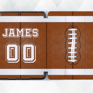 May include: Brown and white football-themed iPad case with the name "JAMES" and the number "00" printed on the front.
