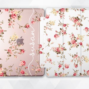 May include: A pink and white floral iPad case with a clear back and a white inscription that says "Susan".