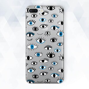 May include: A clear phone case with a pattern of black and blue eyes. The case is designed for an iPhone.