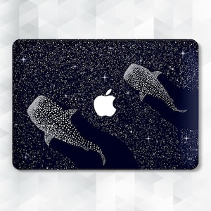 May include: A dark blue laptop skin featuring a starry night design with two white whale shark illustrations and a white Apple logo. The whale sharks are covered in white spots, and the background is filled with white stars.
