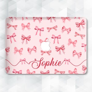 May include: Pink laptop skin with a watercolor bow pattern and the name "Sophie" written in cursive.