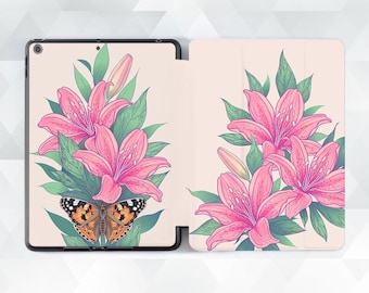 May include: Tablet case featuring a vibrant illustration of pink lilies and green leaves. A detailed butterfly with orange, black, and white markings is centered below the flowers. The case is open, revealing the interior design.