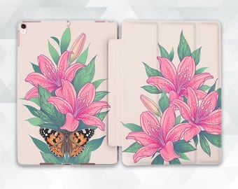 May include: A light beige tablet case featuring a floral design with pink lilies, green leaves, and a butterfly with orange, black, and white markings. The case is open, revealing the tablet screen.