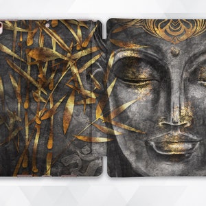 May include: A black and gold iPad case with a design of a Buddha face and bamboo leaves.