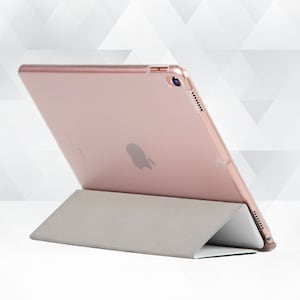 May include: A rose gold iPad case with a stand. The case is made of a hard plastic material and has a soft, microfiber lining. The stand is made of a durable plastic and folds out to provide a comfortable viewing angle.