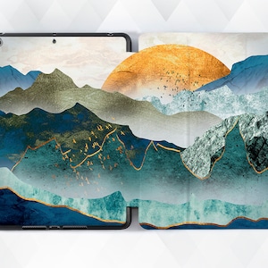 May include: A tablet case with a geometric mountain landscape design. The case features a blue, green, and gold color scheme with a stylized sun in the background.