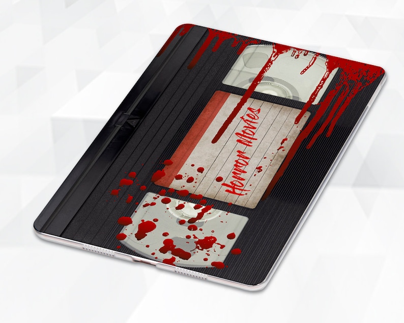 May include: A black VHS tape with a red label that says "Horror Movies" and red blood splatters on the tape.