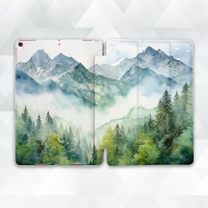May include: A watercolor painting of a mountain range with a forest in the foreground. The mountains are painted in shades of blue and green, and the forest is painted in shades of green. The painting is on a white background.