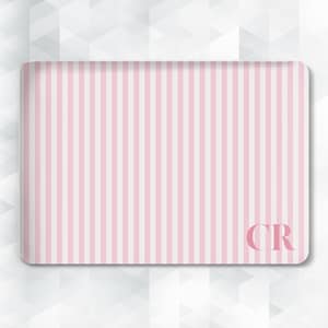 May include: Rectangular tray with a pink and white vertical stripe pattern. The tray has rounded corners and the initials "CR" in the lower right corner. The background is a white geometric pattern.