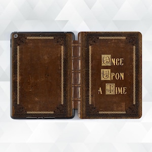 May include: A brown leather iPad case with a gold embossed design and the words "Once Upon A Time" on the front.