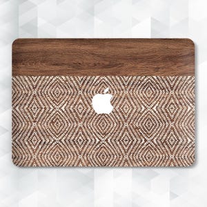 May include: Laptop skin with a two-tone design. The top section features a wood grain pattern, while the lower section showcases a repeating diamond pattern in brown and white. The Apple logo is visible in white.