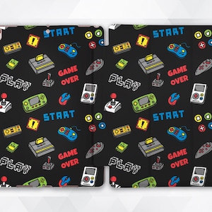 May include: A black and white iPad case with a repeating pattern of retro video game controllers, game consoles, and the words "PLAY", "START", and "GAME OVER".