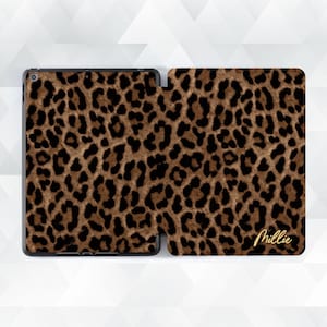 May include: A tablet case with a leopard print design in shades of brown and black. The case is open, revealing the screen and the interior. The name "Millie" is written in gold script on the cover.