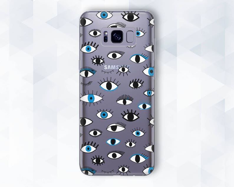 May include: A clear phone case with a pattern of blue and black eyes. The case is designed for a Samsung phone.