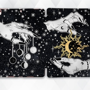May include: A black and white illustration of two hands with long nails against a black background with white stars. One hand is holding a pendulum with three moons. The other hand is holding a gold sun with a crescent moon inside.