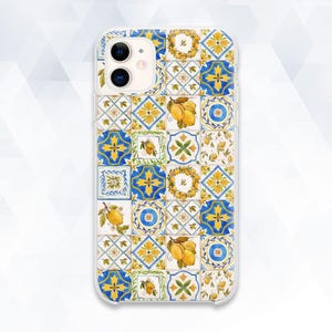May include: A clear phone case with a colorful design of blue, yellow, and white tiles featuring lemons. The case has a cutout for the camera lens.