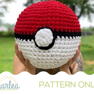 May include: A crochet pattern for a red, white, and black Pokeball. The pattern is available for purchase.