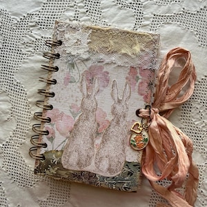 May include: A set of three ceramic mugs with a speckled, matte finish. The mugs are in shades of cream, light gray, and dark gray. Each mug has a simple, minimalist design and a rounded handle.