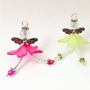 May include: Three beaded angel ornaments with wings, each with a different colored skirt: pink, yellow, and blue.