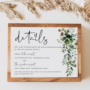 May include: A wooden sign with the word "details" written in black script with a heart symbol. The sign has a white background with green watercolor foliage and text listing two hotels with addresses in Brunswick, 12345. The text also includes the website address www.ourwedding.com.