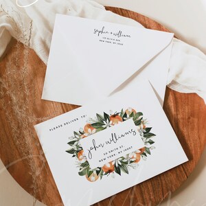 May include: A white envelope with the text "sophia + william" and an address. A white card with a floral wreath of orange blossoms and the text "PLEASE DELIVER TO: john williams 50 SMITH ST. NEW YORK, NY 10007" and the text "SUNSHINEWEDDINGPARTY.COM WEDDING PARTY".
