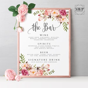 May include: A printable sign for a wedding bar menu with pink floral designs. The sign lists the drinks available, including wine, spirits, beer, and a signature drink.