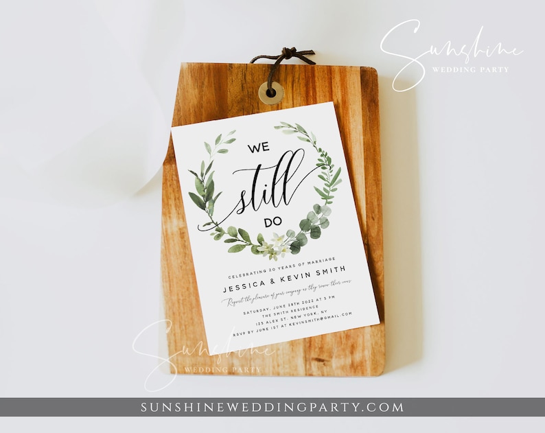 May include: A white wedding invitation with green foliage and white flowers around the text "WE still DO". The invitation is for Jessica and Kevin Smith's 20th wedding anniversary celebration on Saturday, June 18th, 2023 at 5 pm at the Smith Residence, 123 Alex St, New York, NY.