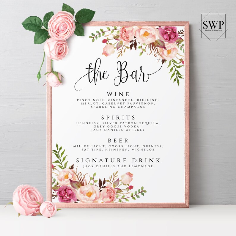 May include: A printable sign for a wedding bar menu with pink floral designs. The sign lists the drinks available, including wine, spirits, beer, and a signature drink.