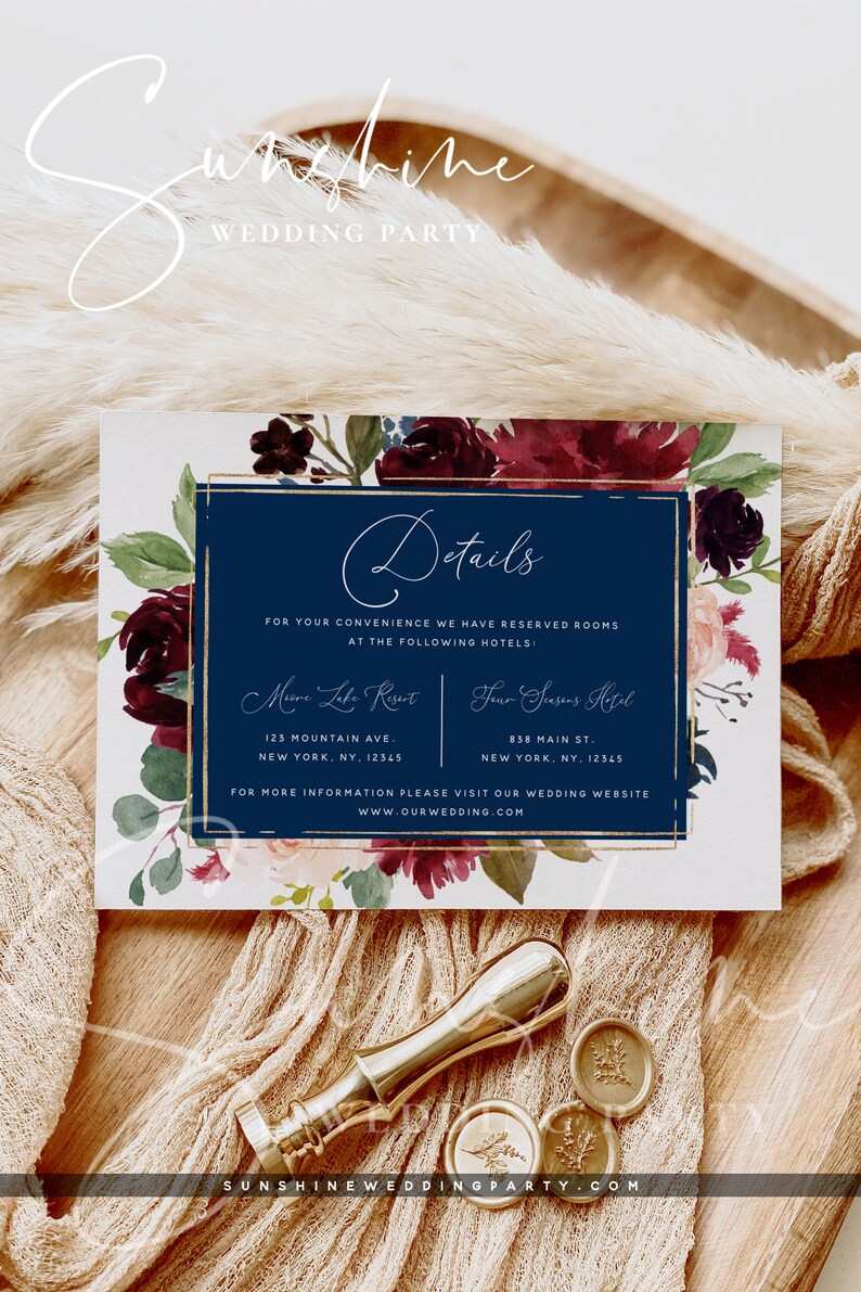 May include: A wedding invitation with a navy blue background and gold accents. The invitation features a floral design with burgundy and pink flowers. The text on the invitation reads "Details" and provides information about hotel accommodations for the wedding. The text also includes the website address "www.ourwedding.com".
