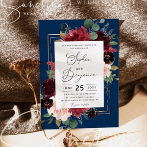 May include: A navy blue wedding invitation with a gold frame and burgundy floral design. The invitation reads "You are cordially invited to the wedding of Sophia and Benjamin June 25, 2024 4 o'clock in the afternoon St. John Baptist Church 125 Willington St. New York, NY Reception to follow"