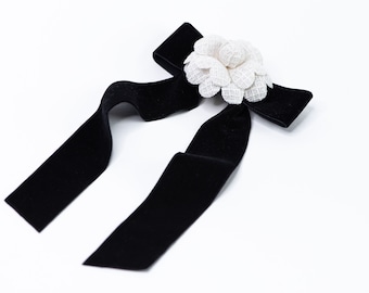 Black velvet hair bow with ivory camellia flower