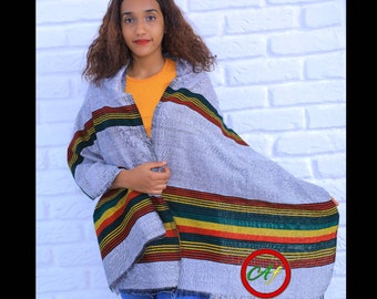 May include: A gray and white striped shawl with colorful stripes of red, yellow, green, and black. The shawl is draped over a person's shoulders. The text "Abelfashion" is visible in the bottom right corner of the image.