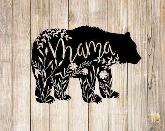 May include: Black silhouette of a bear with the word "Mama" inside the outline. The bear is surrounded by floral designs.