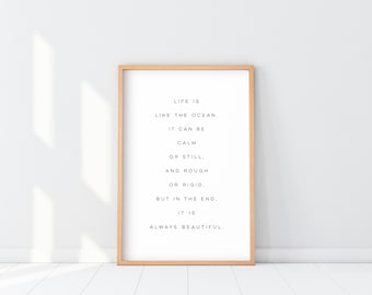 May include: A framed print with a quote about life being like the ocean. The quote reads: "Life is like the ocean. It can be calm or still, and rough or rigid, but in the end, it is always beautiful."