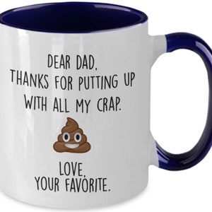 May include: White ceramic mug with a navy blue interior and handle. The mug features the text "DEAR DAD. THANKS FOR PUTTING UP WITH ALL MY CRAP. LOVE, YOUR FAVORITE." along with a cartoon poop emoji.
