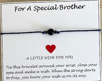 May include: A white card with the text "For A Special Brother" and "A Little Wish For You". The card also includes instructions for making a wish with a bracelet. The bracelet is blue with a black bead.