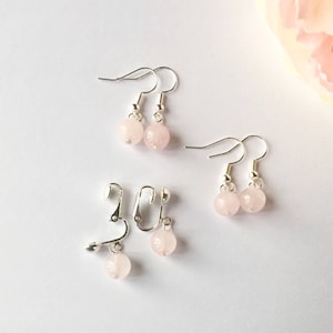 May include: A set of four pink rose quartz earrings, two pairs of clip-on earrings and two pairs of drop earrings.