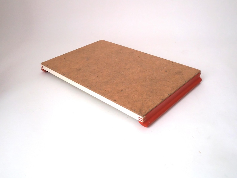 May include: A rectangular wooden tray with a light brown finish and red painted edges. The tray is made of wood and has a simple design.