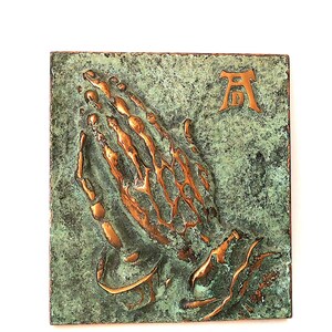 Vintage religious wall plaque praying hands by Albrecht Dürer, solid brass wall hanging with green patina decor, mid century wall decor