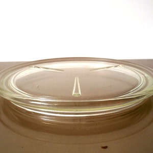 May include: A clear glass serving tray with three sections. The tray has a raised rim and a smooth surface.