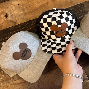 May include: A rustic wooden sign with the text "Welcome to our home" in white lettering. The sign has a distressed finish and a simple, inviting design, suitable for a front porch or entryway.