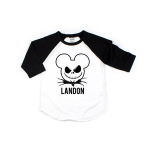 Puede incluir: Camiseta de b&eacute;isbol blanca y negra con una cabeza de Mickey Mouse en blanco y negro con una cara de Jack Skellington y el nombre Landon impreso debajo.