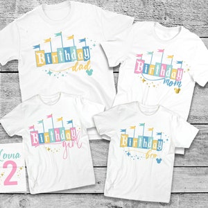 May include: Four white t-shirts with a colorful castle design and the words "Birthday dad", "Birthday mom", "Birthday girl", and "Birthday bro".